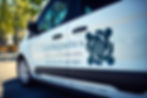 Side view of a Caring Miles non-emergency medical transportation van showing the company logo, contact number (714) 460-0825, and branding text on the door