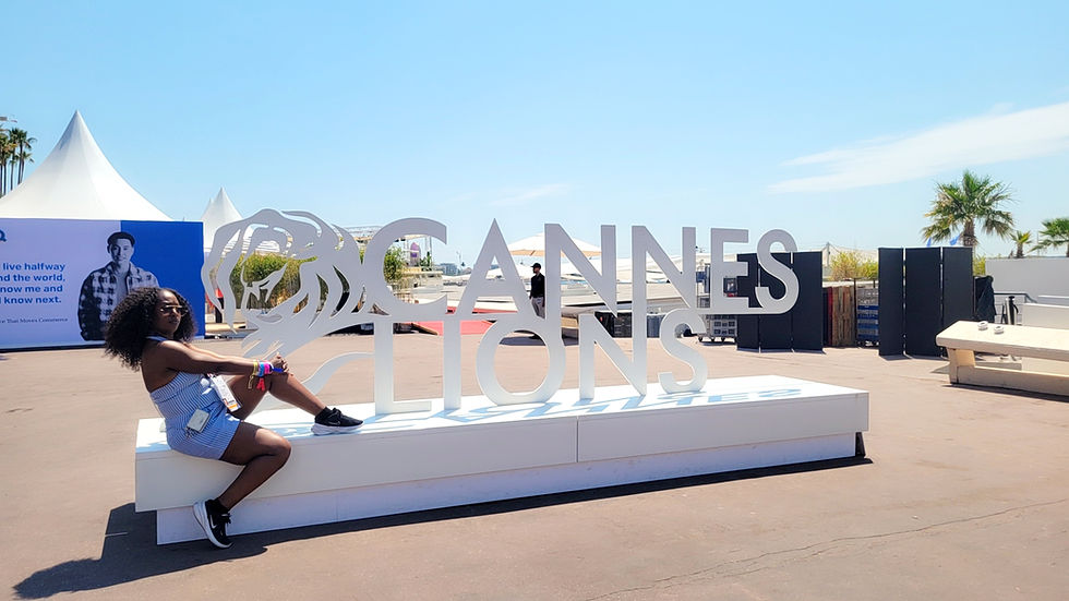 Eye-level view of the Cannes Lions festival beach area with colorful umbrellas and sunbathers