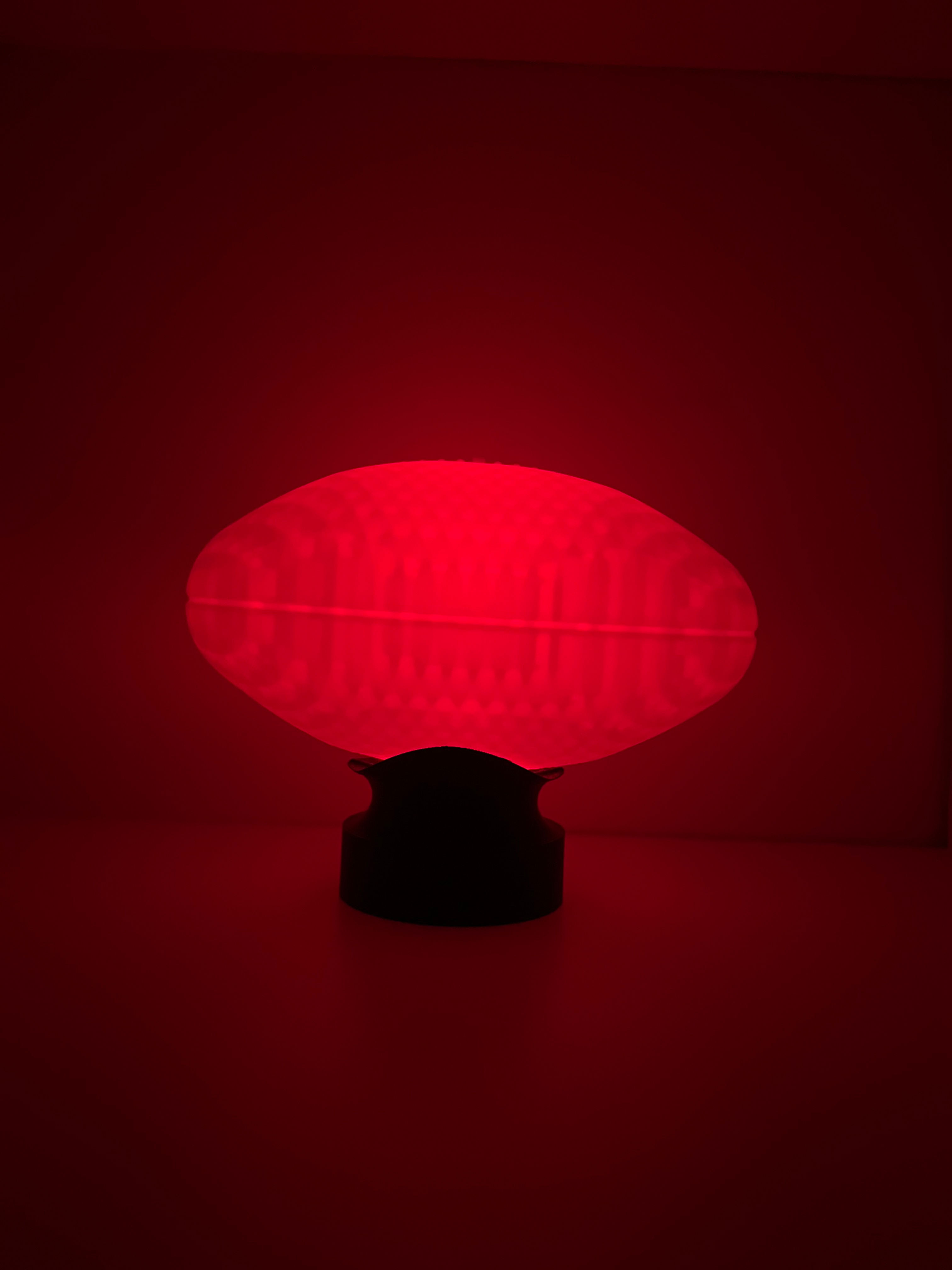 AFL football push lamp glowing red in the dark