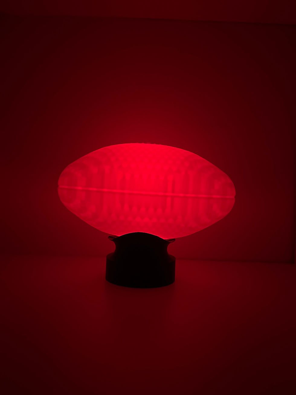 AFL football push lamp glowing red in the dark