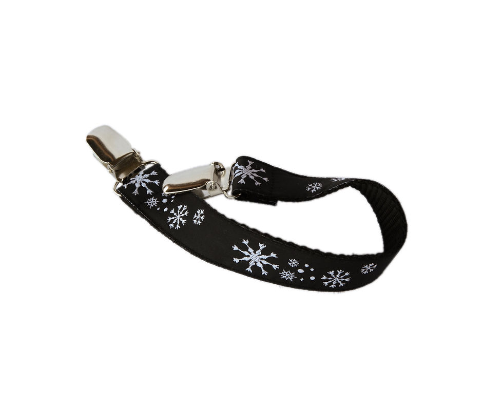Winter cap strap in snowflake pattern. Can be clipped to collar and hat to stop it flying off.
