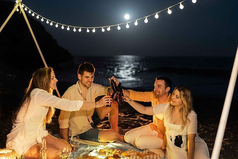 friends-celebrating-toasting-beach-night.jpg