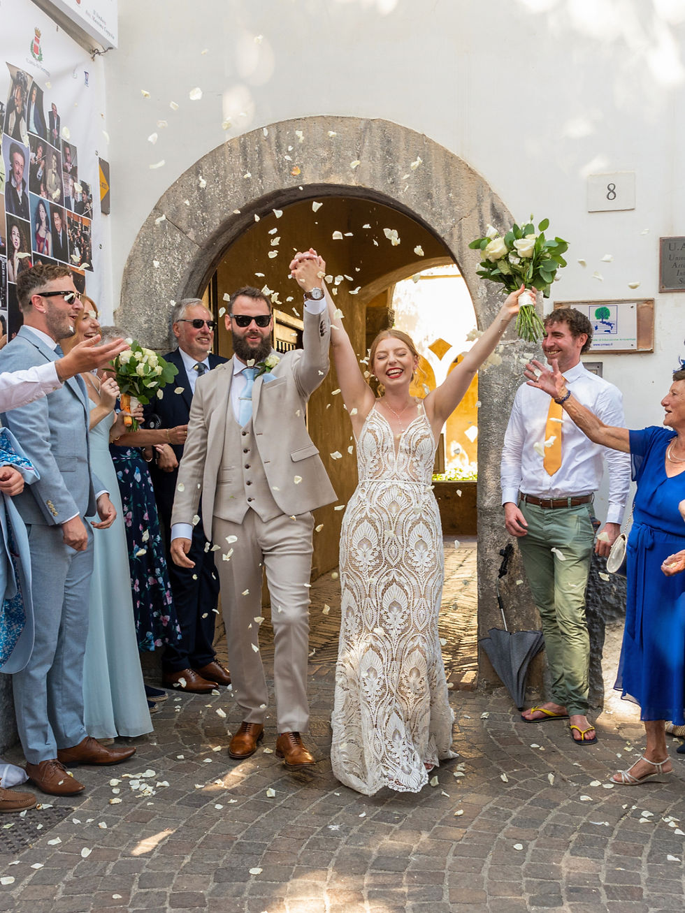 High angle view of a couple lighting unity candles during a cliff-top wedding ceremony in Positano