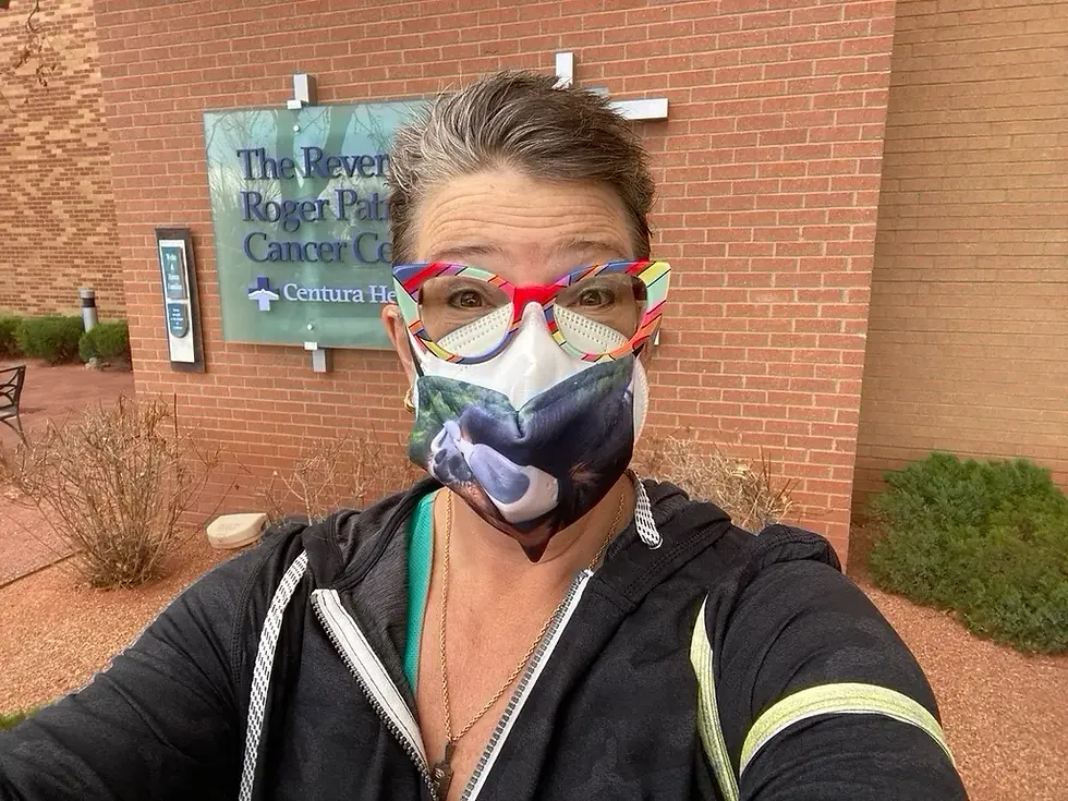 A masked CC standing outside radiation center with her signature red glasses and smiling with her eyes. Radiation begins today!