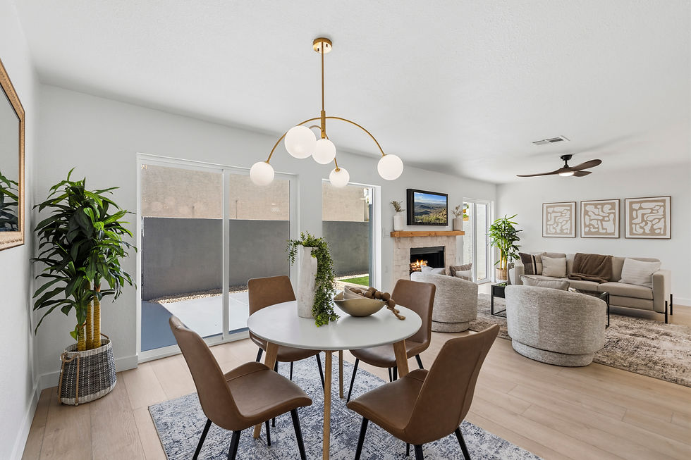 Modern living room with brown chairs around a white table, large plants, a lit fireplace, and abstract art. Bright, open, and inviting.