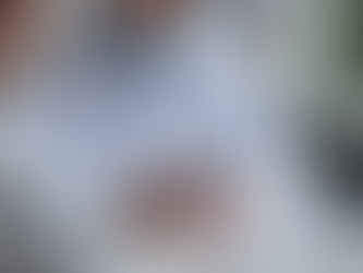 A medical resident in a white coat sits at a desk, appearing unsure, while searching "drug dosage" on Google using a smartphone and writing a prescription for a patient. Medical charts, a prescription pad, and a stethoscope are on the desk.