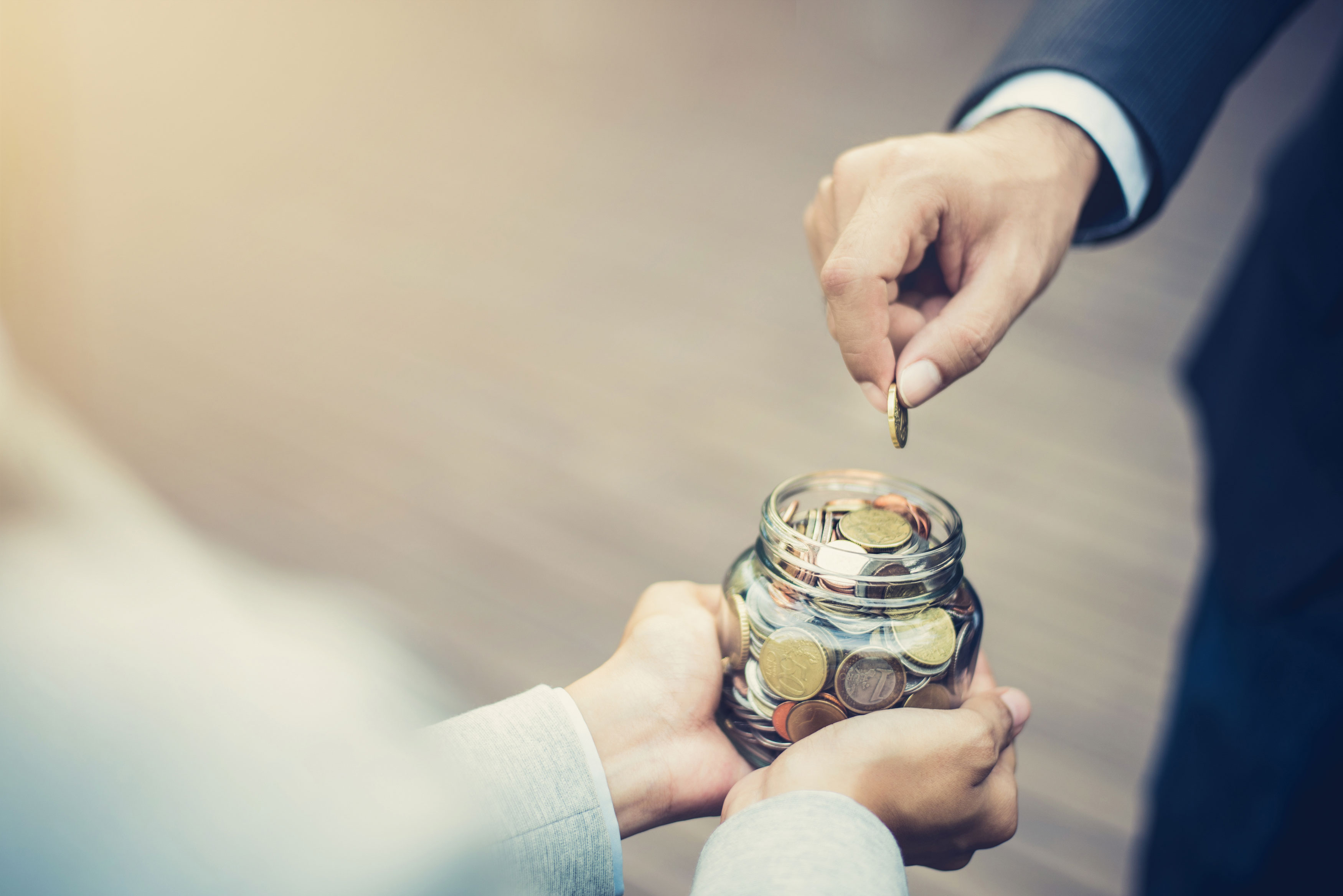 Donating by putting change into a jar.