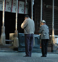 Japanese praying at a Shinto shrine