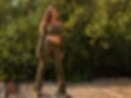 Woman wearing olive green Bamboo Lace Up Back Crop Top with flare sleeve by Catana Clothing.