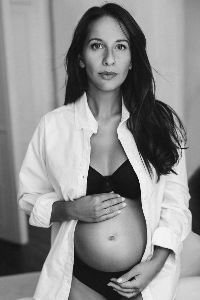 Empowered pregnant woman holding her belly in NYC portrait studio