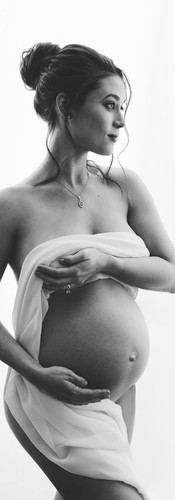 Black and white maternity portrait of elegant woman at luxury NYC photo studio