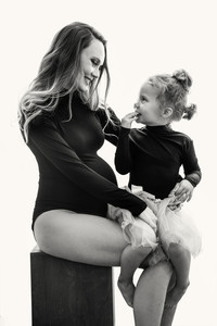 Black and white maternity portrait of a pregnant mother and her daughter
