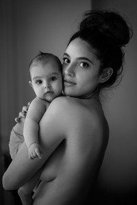 Natural light maternity portrait of a woman and her newborn