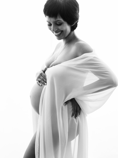 Luxury maternity portrait using silk fabric and soft studio lighting photographed by Alice Prenat in NYC.