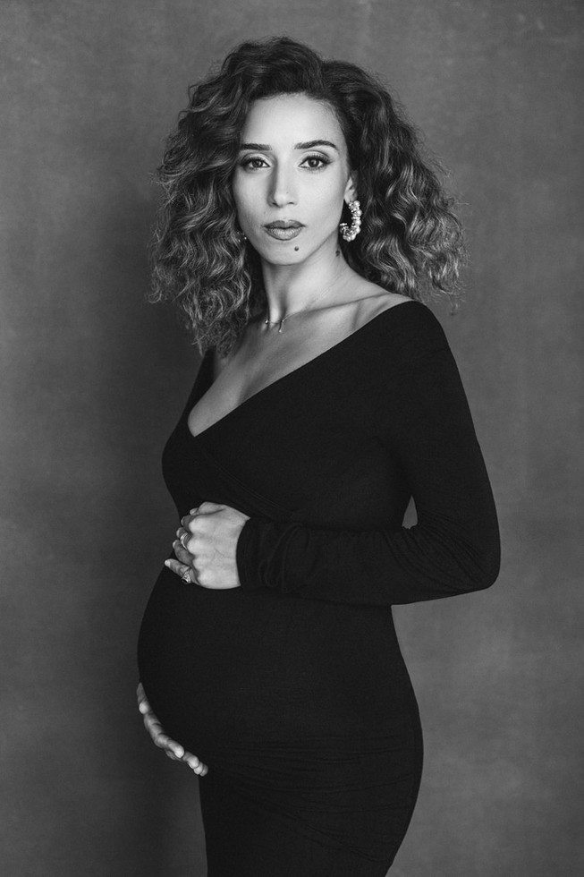 Expecting mother in black maternity dress during NYC photo session