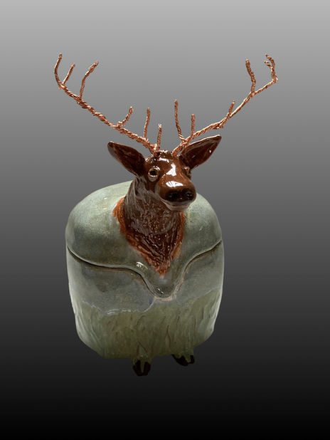 Ceramic deer sculpture with detailed antlers and textured body, brown and green.