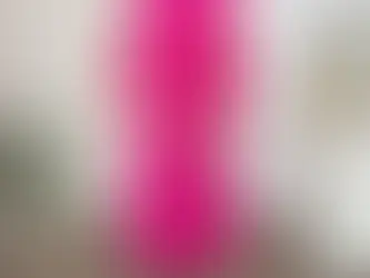 A Woman Wearing a Pink Large pleated dress, showcasing its loose fit and elegant pleats