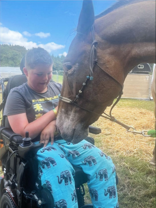 Theodore outside with a horse