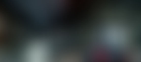 A lone car stops at a red light on an empty, rain-slicked city street at night, suggesting obedience to a rule even when no one appears to be watching.