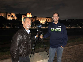 Posing with a client with the Roman ruins in the background on a Rome by Night Photo Tour Under the Stars provided by Giulio D'Ercole.