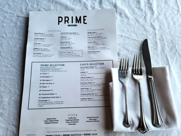 prime boji menu on white tablecloth and silverware napkin setup