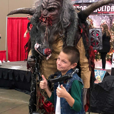 Kid taking picture with Krampus