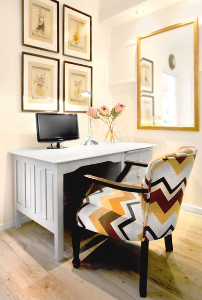 Home office with a grey desk and patterned chair