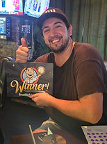 Music bingo winner giving a thumbs up at Mickey Burkes in Miami Beach, FL