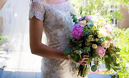 a photo of a bride holding her garden inspired bridal bouquet