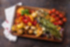 Grilled vegetables on cutting board on dark wooden background.jpg