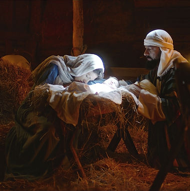 Mary and Joseph caressing baby Jesus in illuminated manger_edited.jpg