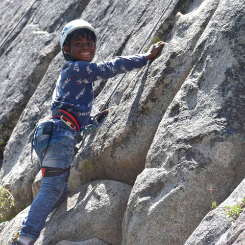 Champ camp burn survivor child rock climbing