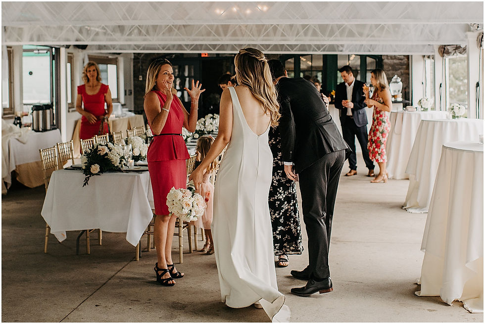 Family members greet a bride and groom on the patio of a Buffalo wedding venue.