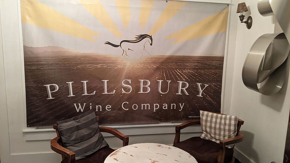 A Pillsbury Wine Company banner forms the backdrop for a small conversation space.