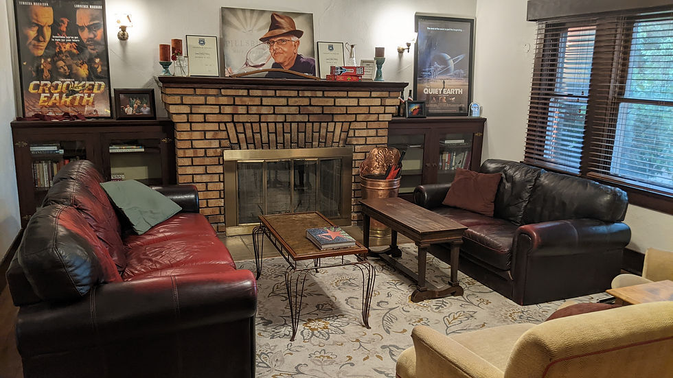 Comfy couches lie in front of a brick fireplace.