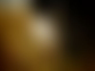 A white Halloween-style mask held by someone in a black long-sleeve shirt, symbolizing scary skincare mistakes to avoid this fall.