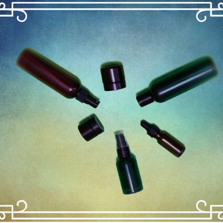 A circle of Aromatic Rituals containers without labels, placed on a blue-green background, symbolizing eco-friendly reuse and sustainability
