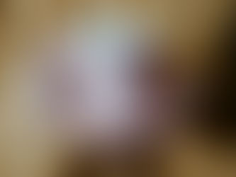 Hands holding a warm pink mug against a cozy sweater, symbolizing comfort, softness, and gentle winter self-care rituals