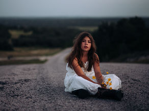Little girl playing with flowers in the Texas Hill Country