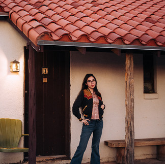 Girl standing in front of road side motel room