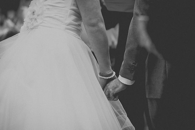 bride and groom holding hands