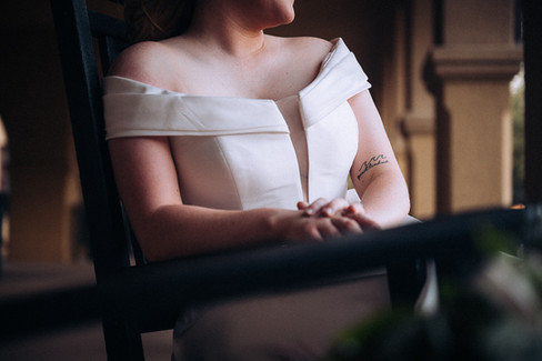 close up of brides hands and arms only sitting in rocking chair at the Fort Worth stockyards in Fort Worth texas
