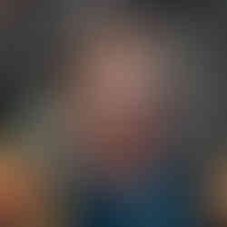 tween girl lookin into color sitting on a colorful blanket