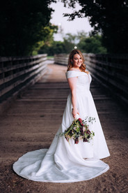 bride standing on beautiful wood bridge at the Fort Worth stockyards in Fort Worth texas