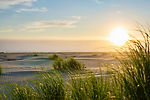 Sunset over the beach and dune grass at Breakwater Resort on the Grayland, WA coast