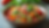Eye-level view of a colorful bowl of fresh vegetables and grains