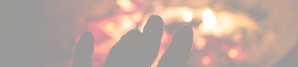 person's hand near fire pit