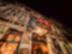 The exterior of Szimpla Kert, Budapest’s iconic ruin bar, with its eclectic, weathered facade and dim, colorful lights illuminating the entrance—perfect for a unique stag party experience.
