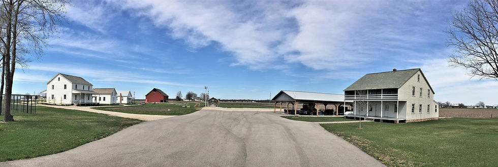 A series of farm houses and barns.