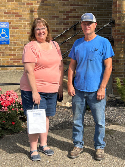 Woman and man standing on a sidewalk outside  the Wabash County Courthouse in Mt. Carmel, Illinois